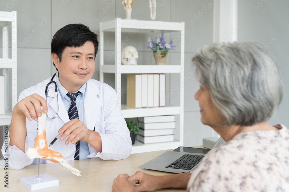 Obraz premium Doctor, elderly woman and model of the feet. Male doctor explaining anatomical feet with elderly patient woman in office clinic.