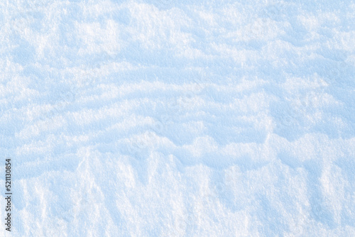 Close-up of fresh snowy land in the winter on a sunny day  viewed from above. Abstract full frame textured background. Copy space. Top view.