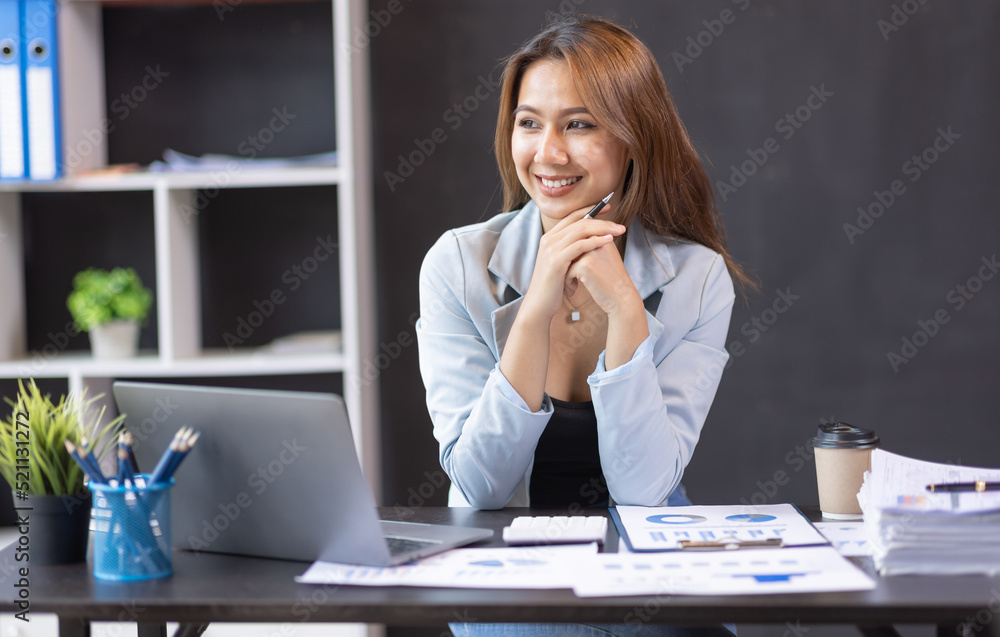 Young business Asian woman working on laptop computer in modern office. doing finances, accounting analysis, report data pointing graph Freelance education and technology concept. Young business Asian woman working on laptop computer in modern office. doing finances, accounting analysis, report data pointing graph Freelance education and technology concept.