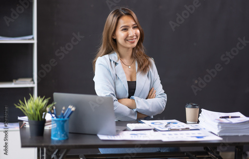 Young business Asian woman working on laptop computer in modern office. doing finances, accounting analysis, report data pointing graph Freelance education and technology concept.