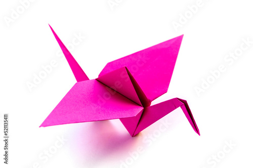 Pink paper crane origami isolated on a white background