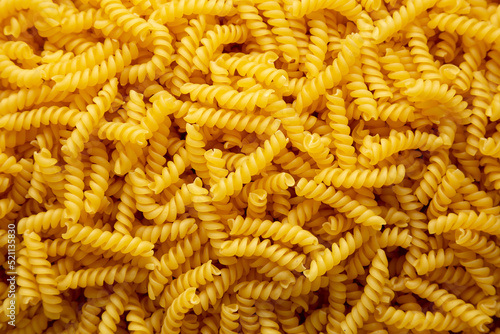 Uncooked dry girandole torsades pasta background