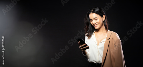 Half body portrait of Asian beautiful woman wear white shirt, using internet smart phone