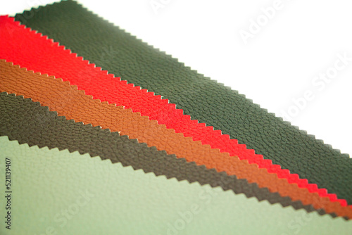 Colorful and bright fabric samples of leatherette furniture and clothing upholstery. Close-up of a palette of textile abstract stripes of different colors