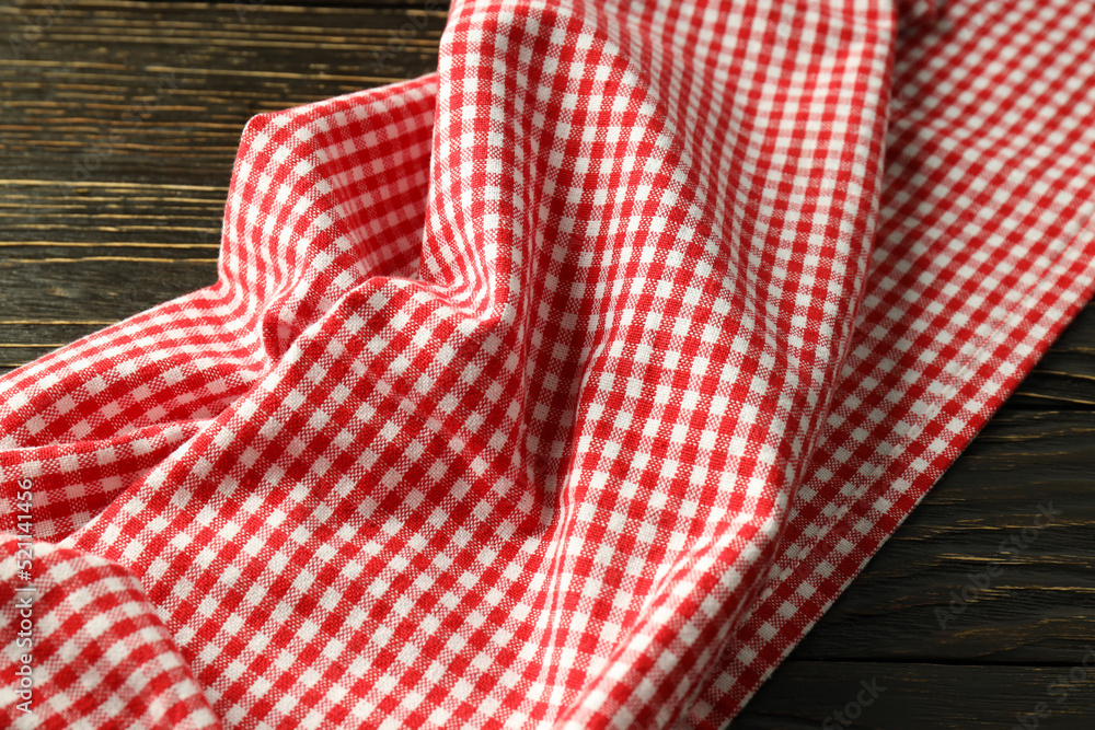 Red and white checkered tablecloth on wooden background Red and white checkered tablecloth on wooden background