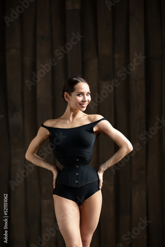 Portrait of a smiling sensual dancer female slim figure posing in the studio. Body ballet © BestForYou