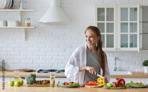 Beautiful woman in the kitchen while preparing a vegetarian breakfast. Healthy eating.