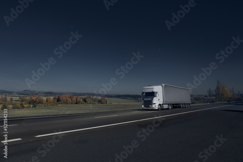 Truck driving through the night landscape at moonlight
