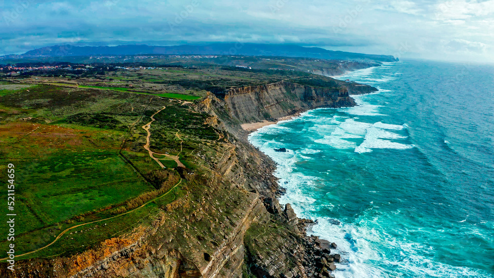 Beautiful landscape of Atlantic ocean coastline, Portugal. Aerial view of Scenic tourist travel destination. No people. Summer. Cloudy sky. Drone top view - natural seascape with ocean rocky shore