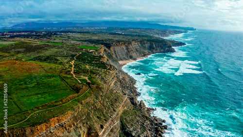 Beautiful landscape of Atlantic ocean coastline, Portugal. Aerial view of Scenic tourist travel destination. No people. Summer. Cloudy sky. Drone top view - natural seascape with ocean rocky shore