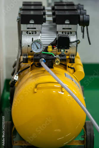 yellow pump air compressor in the workshop