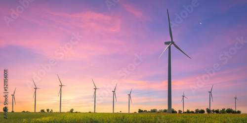 Wind turbines park at sunset - Eolic park - Green ecological power energy generation - Wind farm eco field - Green energy concept photo