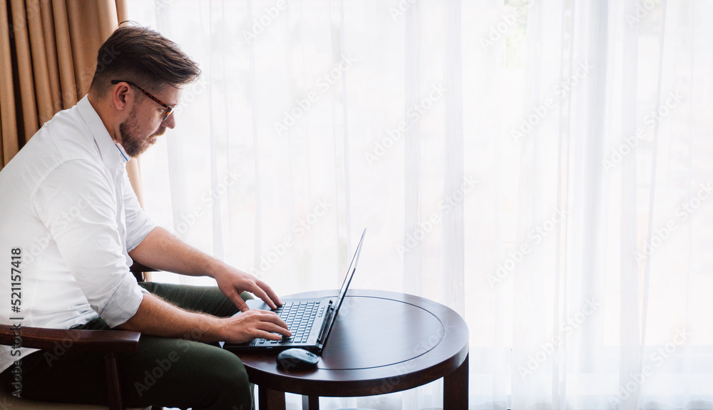 Man, businessman working on laptop, remote tasks, project manager.