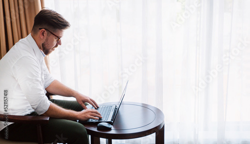 Obraz na płótnie Man, businessman working on laptop, remote tasks, project manager. w salonie
