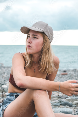 Travel.Traveler girl resting on the beach near the sea. Eco travel, taking care of yourself physical and mental health. Slow life and sea holidays. work and leisure travel. Traveling outdoor