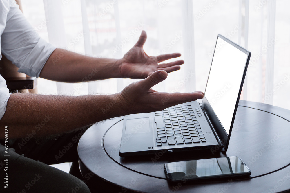 Man working on a laptop, hands close-up, remote work, photo on a light background, project management.