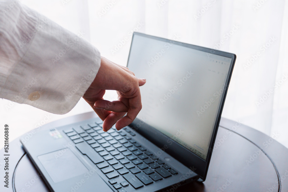 A woman working on a laptop, closeup of her hands and keyboard, the blank screen in the form of a clean template, businesswomen in the office on a light background.