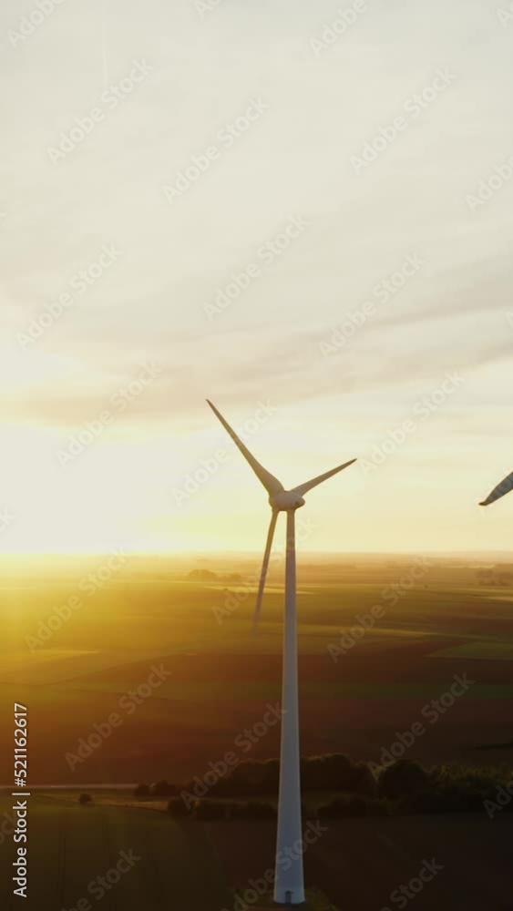 Horizontal panning from a drone, view of a wind farm among fields Horizontal panning from a drone, view of a wind farm among fields