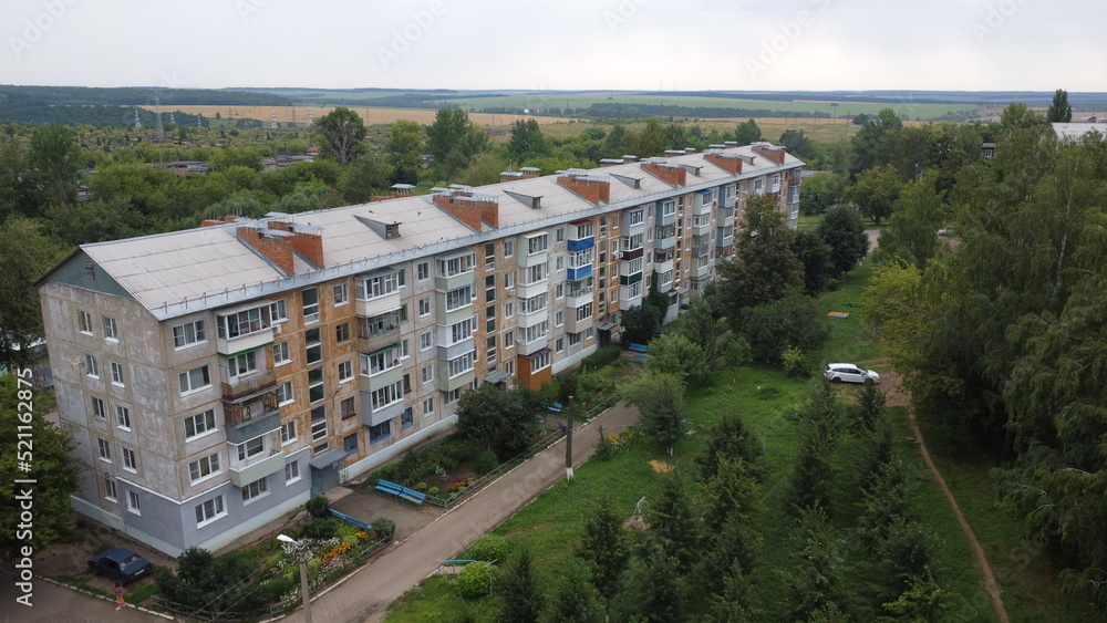Fototapeta premium Five-story panel house in a residential area of a provincial town.