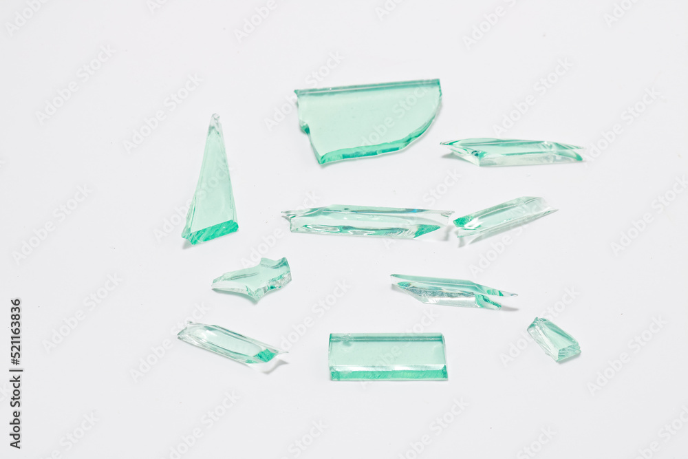 Abstract broken green glass in motion into pieces isolated on white background. Abstract broken green glass in motion into pieces isolated on white background.