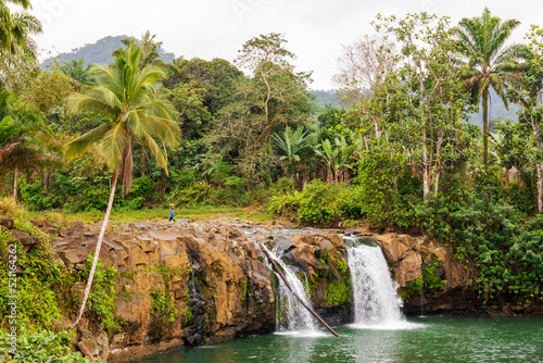 The double waterfall of Ribeira Peixe where the river water leaves the jungle and enters the sea on the tropical  island of São Tomé.