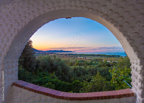 Sardegna (Italy) - The worderful and wild east coast of Sardinia region, in the area of Gallura and Supramonte mountain range, with La Caletta port town at sunset