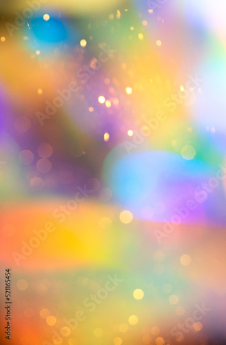 Abstract colourful rainbow background with golden bokeh for design of festive background.