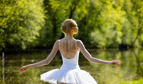 ballerina girl, in a white tutu, trains in the park, in the early morning. Graceful girl, secrets of beauty and youth, Russian ballerina woman
