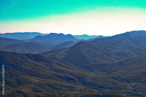 Mountain panorama of peaks covered with green forest