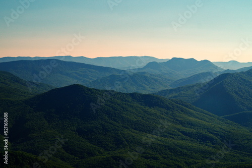 Mountain panorama of peaks covered with green forest