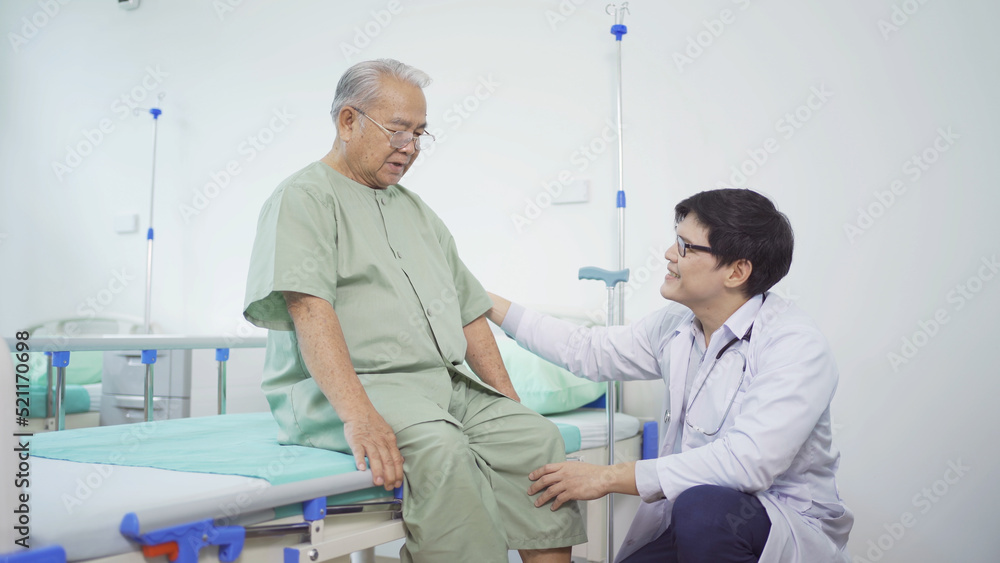 Fototapeta premium Happy old elderly Asian patient or pensioner and a doctor smiling, doing exercise, working out in nursing home in hospital. Senior people lifestyle activity recreation. Health care physical therapy.