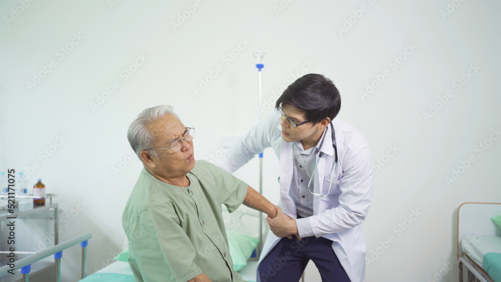 Obraz premium Happy old elderly Asian patient or pensioner and a doctor smiling, doing exercise, working out in nursing home in hospital. Senior people lifestyle activity recreation. Health care physical therapy.