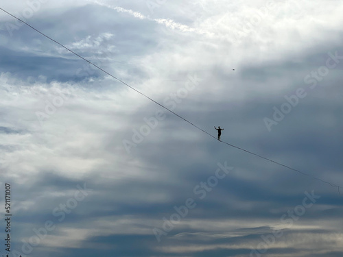 Fotografie French tightrope walker Nathan Paulin walks on a 950 meters long slackline, 50 meters over Geneva Lake between the right and left banks of the city during an event part of the Swiss National Day