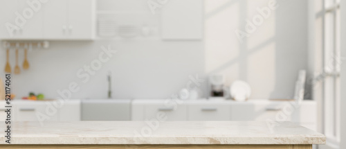 Elegance white marble kitchen tabletop with copy space over blurred white kitchen in background photo