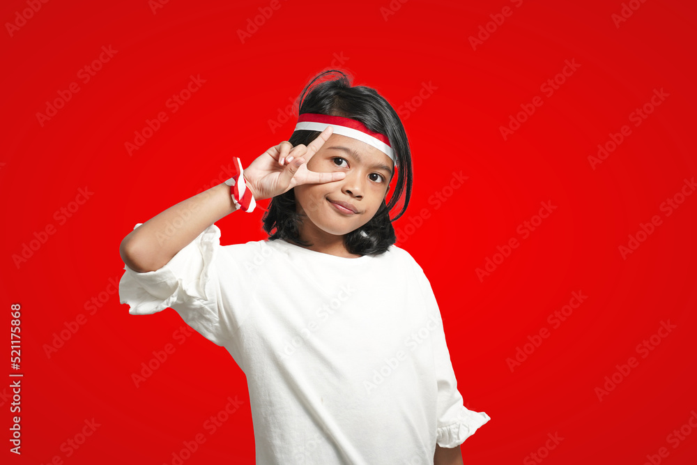 isolated girl wearing red and white ribbon celebrating Indonesian independence in cool style. isolated girl wearing red and white ribbon celebrating Indonesian independence in cool style.