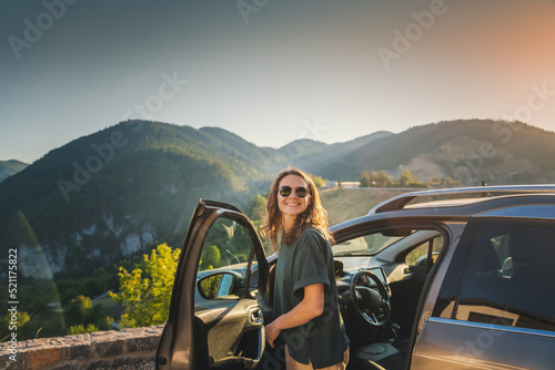Fotobehang Young beautiful woman traveling by car in the mountains, summer vacation and adv