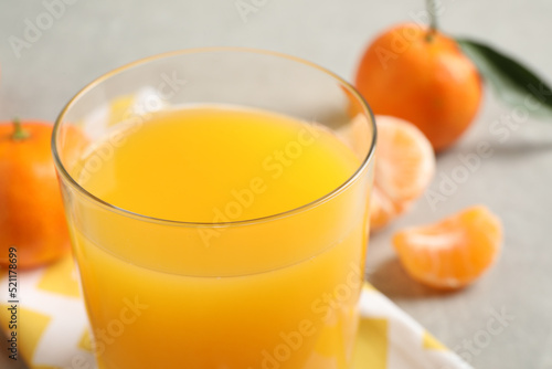 Glass of fresh tangerine juice, closeup view