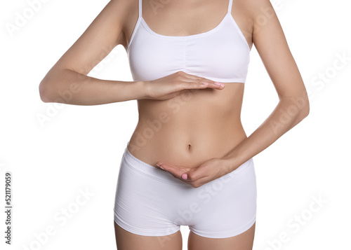 Woman in underwear holding something near her belly on white background, closeup. Healthy stomach © New Africa