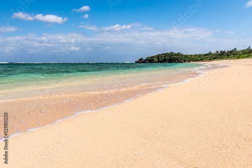 Gentle turquoise sea wave on clean sand beach