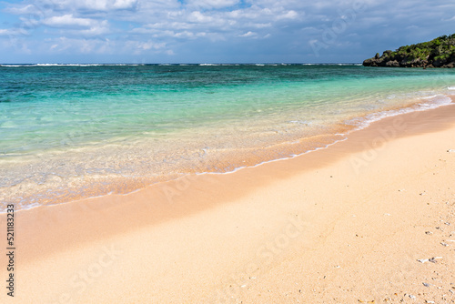 Gentle turquoise sea wave on clear sand beach