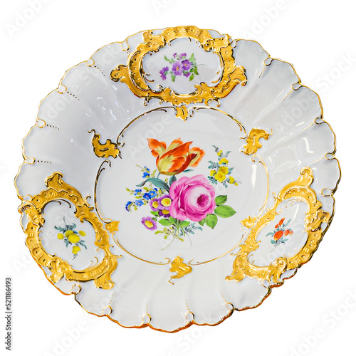 Vintage plate with flower pattern and golden decorations on white background.