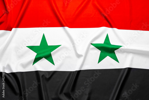 Wavy flag of Syria for background top view photo