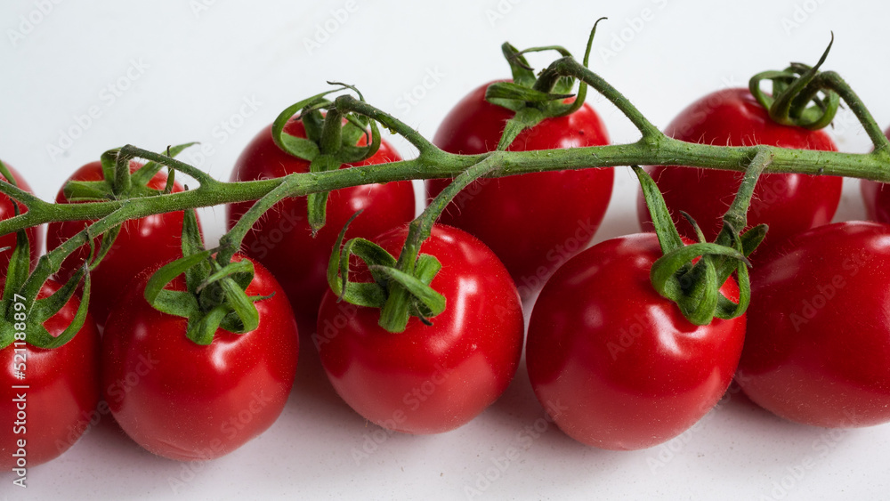 Vibrant close up of cherry tomatoes on vine. Recipes and food preparation concept. Vibrant close up of cherry tomatoes on vine. Recipes and food preparation concept.
