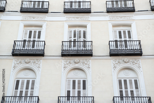 Elegant facade with balconies and shutters. Madrid, Spain