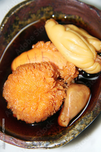 Boiled red sea bream eggs in a small bowl in sweet and spicy soy sauce. photo