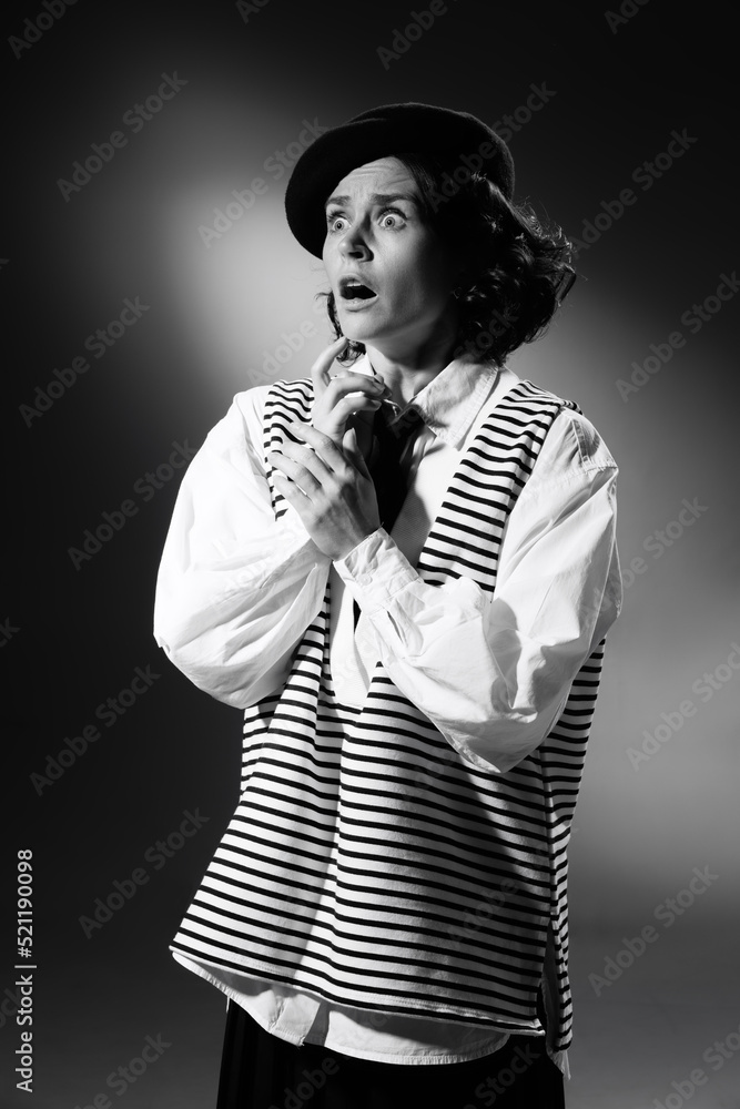 Obraz premium Portrait of beautiful emotive woman in stylish classical clothes, showing emotions of shock and empathy. Black and white photography