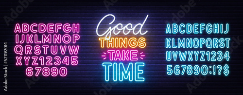 Good things take time neon quote on a brick wall.