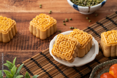Delicious mung bean moon cake for Mid-Autumn Festival food mooncake on dark wood table background.