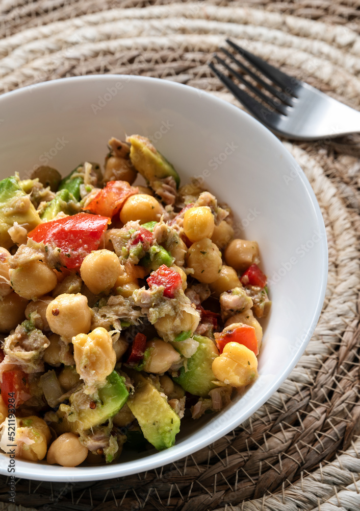 Fresh chickpea salad with tuna, tomato, pepper, onion and avocado