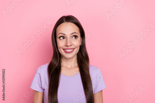 Portrait of positive pretty girl look interested empty space toothy smile isolated on pink color background
